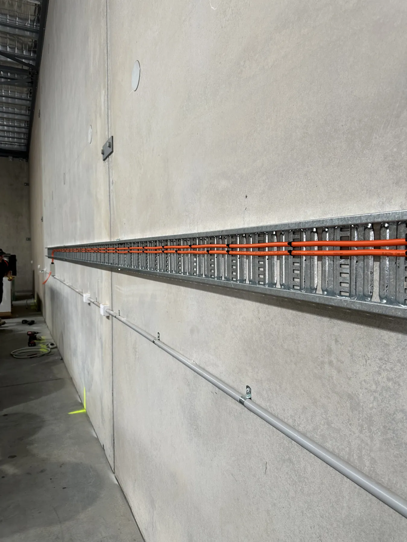 Cable tray and conduit run along a commercial wall