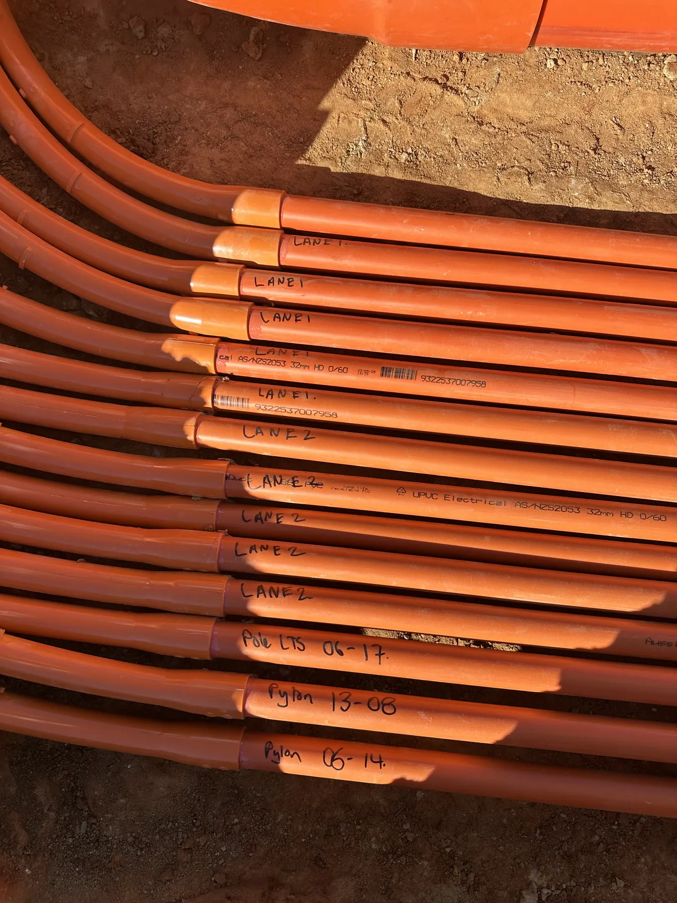 Labelled conduits at the trench head, underground service mains