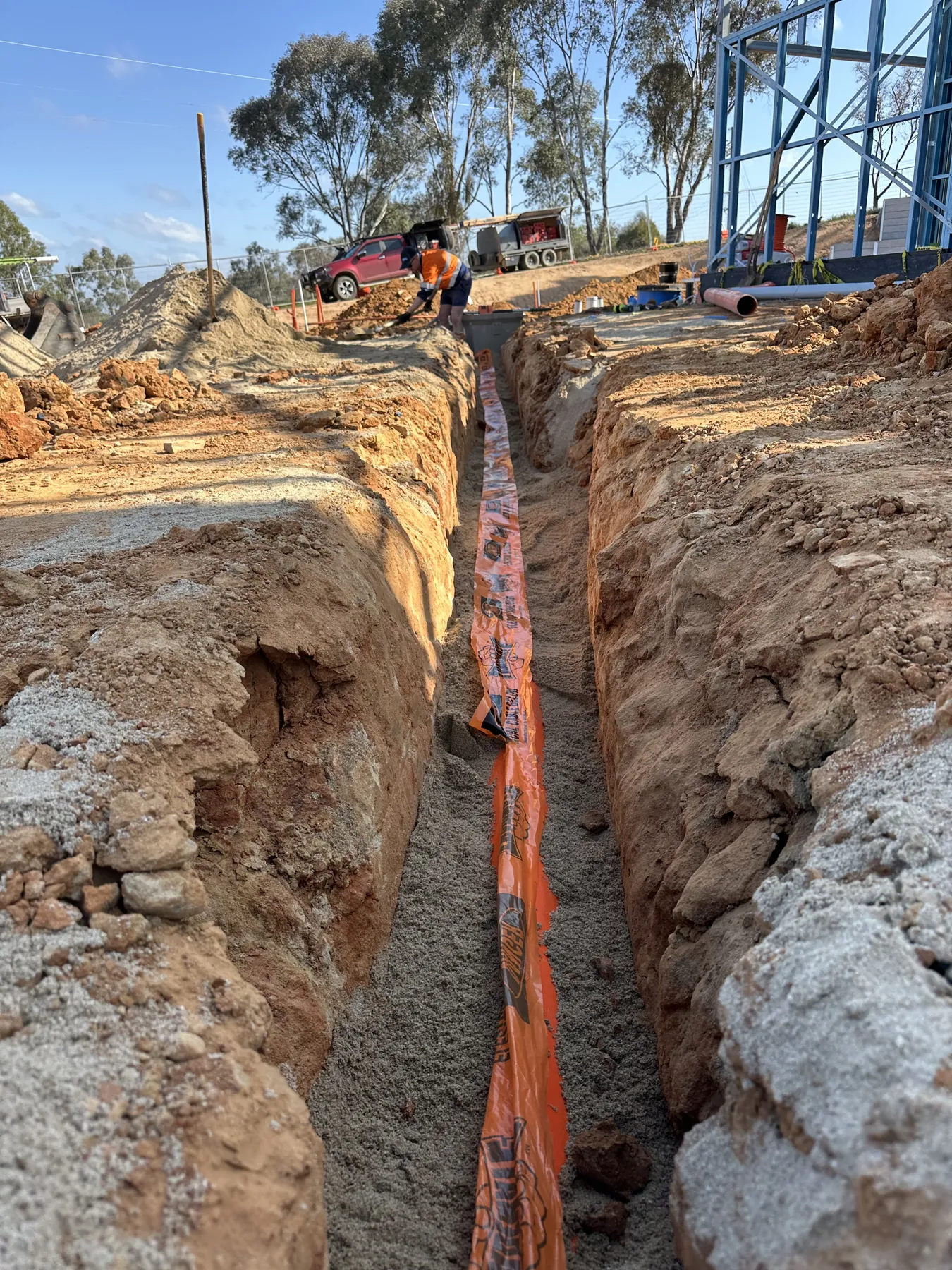 Underground consumer mains conduit run across a building site