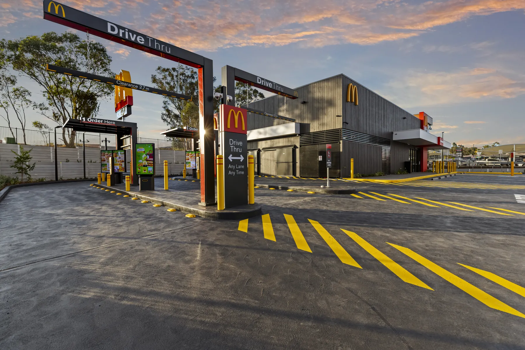 McDonald's drive-thru at dusk, site power and lighting complete